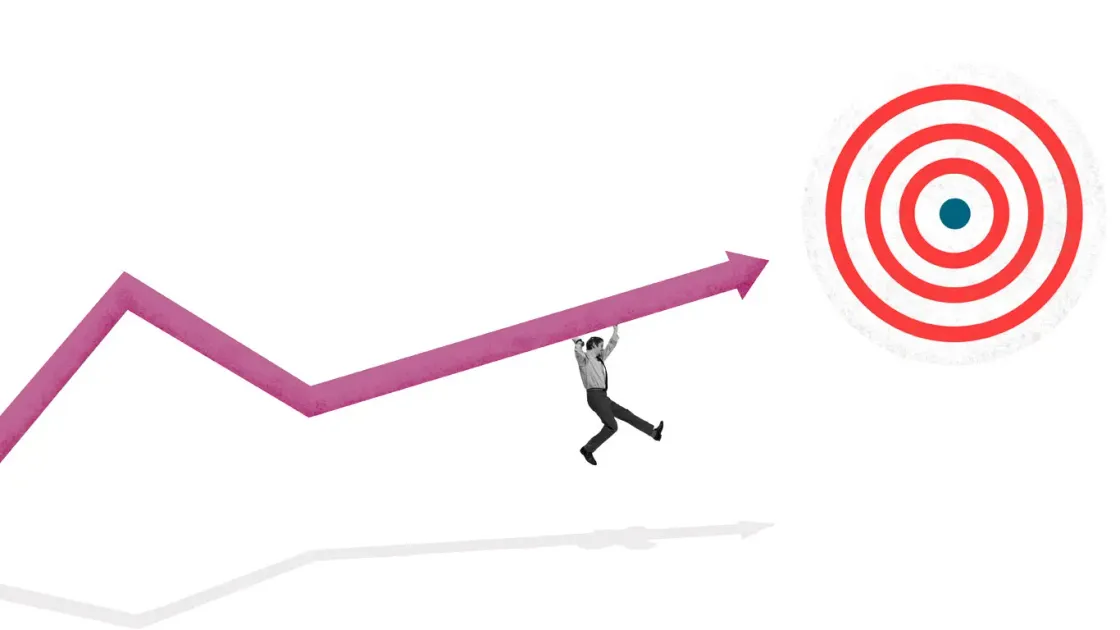 Illustration : un homme porte une courbe de croissance vers une cible, symbolisant les objectifs marketing à Rennes